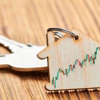 trinket-form-wooden-house-with-keys-apartment-with-real-estate-growth-chart.jpg